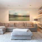 Living room with sofa, rug, and wall art