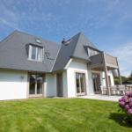 Modern house with terrace and garden. Flowerbeds and clear view.