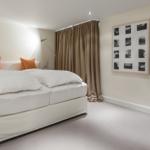 Bedroom with bed, curtains, and wall art
