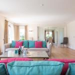 Living room with sofa, coffee table, and garden view