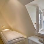Schlafzimmer mit Dachfenster und Blick aufs Meer.