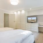 Bedroom with bed, wardrobe, and TV furniture