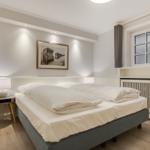 Bedroom with double bed, nightstand, and window.