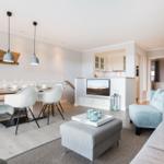 Living and dining area with sofa, dining table, and TV.