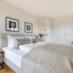 Bedroom with double bed, wardrobe, and armchair.