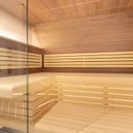 Sauna with wooden benches and glass wall