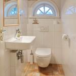 Bathroom with toilet, sink, and bathroom window.
