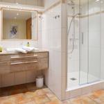 Bathroom with shower, sink, and mirror