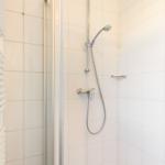 Shower with showerhead and radiator on the wall