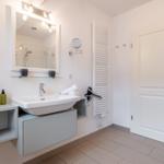 Bathroom with sink, mirror, and shower