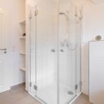 Bathroom with shower, toilet, and shelf