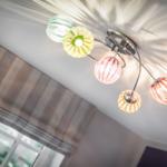 Ceiling light with colorful glass globes and striped pattern.