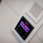 FM radio with display shows frequency and station name.