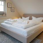 Bedroom with bed, window, and nightstand