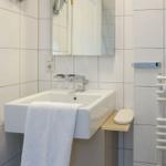 Bathroom with sink, mirror, and towel rack