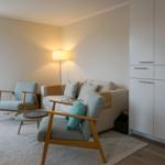 Living room with sofa, two chairs, and a floor lamp.