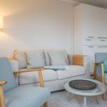 Living room with sofa, two chairs, and small table.