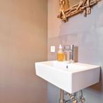 Sink with faucet and soap on the wall