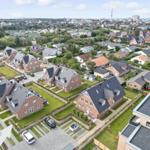 Aerial view of houses with gardens and streets in a town