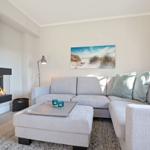 Living room with sofa, fireplace, and wall art