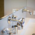 Bathroom with modern faucet and mirror cabinet