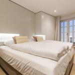 Bedroom with double bed, built-in closet, and window with view.