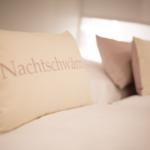 Headboard with pillows bearing the text Nightdreamer.