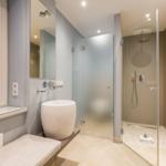 Bathroom with shower, sink, and window