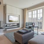 Living room with fireplace, TV, and large window