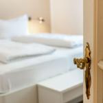 Bedroom with bed and golden door handle