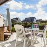 Terrace with table, chairs, and view of houses