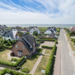Village street with houses and view of the sea