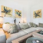 Living room with sofa, cushions, and wall art