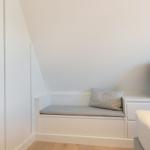 Bedroom with seating, TV, and closet.
