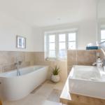 Bathroom with freestanding bathtub and sink with mirror