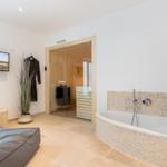 Bath with whirlpool, sauna, and TV