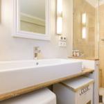 Bathroom with sink, mirror, and shower.