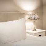 Bed head with pillow and nightstand with lamp