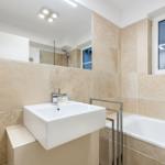 Bathroom with sink, bathtub, and mirror