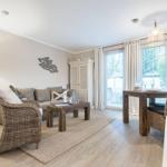 Living and dining area with sofa, dining table, and balcony view.