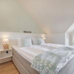 Bedroom with double bed, bedside table, and balcony view.