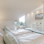Bedroom with double bed, balcony and sliding doors