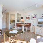 Living and dining area with TV, dining table, and kitchen area.