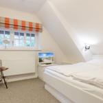 Bedroom with double bed, window and chair