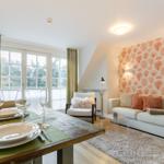 Living and dining area with sofa, table, and window.