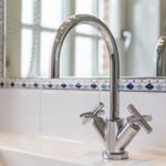 Bathroom with chrome faucet and blue-white tiles
