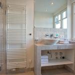 Bathroom with shower, sink, and window