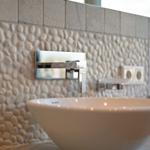 Sink with stone wall and chrome faucet