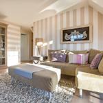 Living room with sofa, side table, and cabinet against the wall.