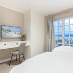 Bedroom with sea view and desk with TV